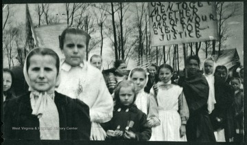 Children holding signs in the street.