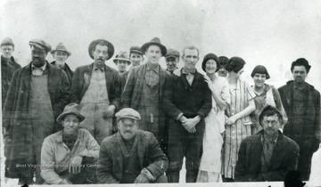 A group of unidentified miners and their families posing for a picture.