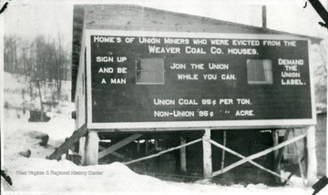 Sign on barracks that reads, 'Homes of Union Miners who were evicted from the Weaver Coal Co. houses.'