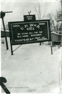 Sign reads, 'Irona, W. Va. Local Union UMWA. No. 4913 We stand 100% for the Baltimore Agreement. Hamstead's for Meat and Groceries.'