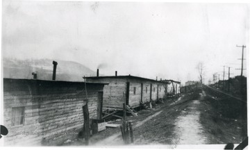 Barracks and dirt road along railroad tracks at Dakota, W. Va.