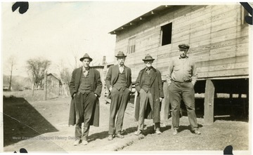 Four men pose for a picture.