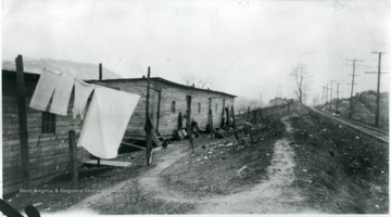 Laundry hanging on line near barracks in Dakota, W. Va. with railroad tracks nearby.