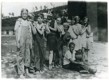 Group portrait of children near the shack. 'For information on the Mountaineer Mining Mission See A&amp;M 2491 (S.C.).'