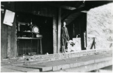 Man and scales visible next to tracks at Fire Creek Head House.