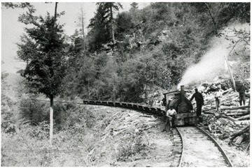 Men stand around the locomotive on the main line at Fire Creek.
