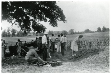 Group of people getting ready to harvest a garden.