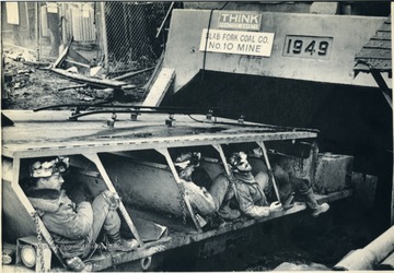 'Miners on the last shift before the United Mine Workers of America members walk-out pending contract ratification ride a mine car into a drift mine at a Slab Fork Coal Company site in southern West Virginia. The shift ends at midnight Thursday marking the begining of the contract strike. (AP Laserphoto) (James Samsell/str52000jls)1981.'