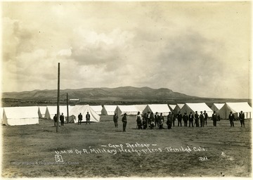 Men stand around the tents at Camp Beshoar.