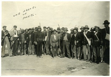 Group portrait of men standing with their ammunitions.