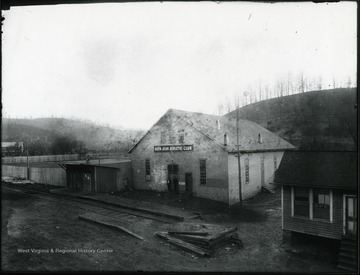 View of Glen Jean Athletic Club building and nearby dentist's office. 'Near Treveys Studio. Trevey's negatives were stored in the attic of this building after he closed his studio. McKell Ballfield on left, famous for a type of softball called Letemhitit.  Insurance agency on right operated by James Long.  Railroad is the K. G. J. [and] E. (Kanawha, Glen Jean, and Eastern). Athletic building contained a pool room, bowling alley, etc.'