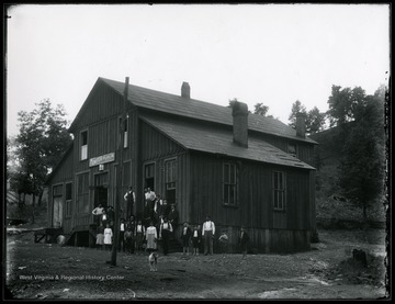 People standing infront of a general store.