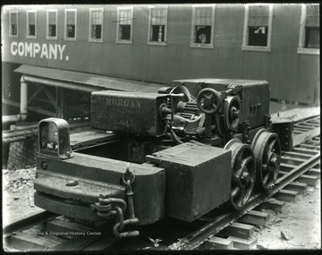 Coal mining car on tracks.  Morgan Locomotive, used the third rail power system.  Notice power line located in center of track.  This eliminated the need for trolley wire and poles.