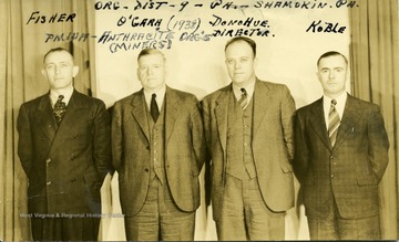Group portrait of anthracite organizers of the P.M.W.A.  'Org- Dist - 9 - Pa. - Shamokin, Pa.'  From left to right, Fisher, O'Gara, Director Donohue, Koble.