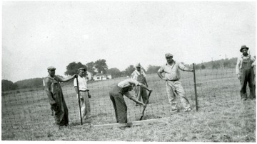 Men work on a fence at the Union Miner's Cemetery.