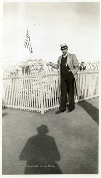 Joe Ozanic standing in front of fenced in memorial/grave.