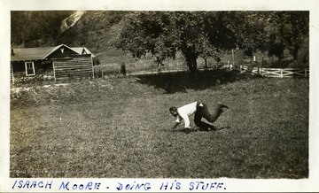 Isaach Moore 'doing his stuff' crawling around out the ground.  Photograph from Joe Ozanic scrapbook.