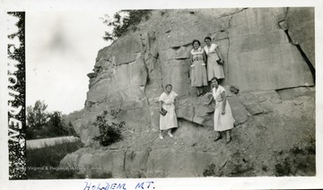 Four women standing on the side of Mt. Holden. 