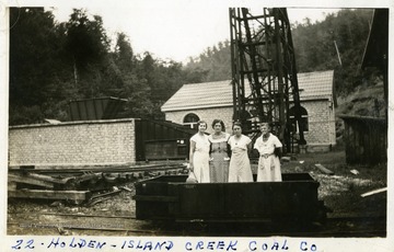 Four women standing in a Holden-Island Creek Coal Company coal car. Photograph from Joe Ozanic scrapbook.