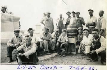 Volunteer workers gathered around a barrel at the Miners Cemetery, Mt. Olive, Ill.