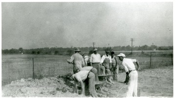 Workers load dirt into wheelbarrows for the Mother Jones Memorial at the Miner's Cemtery, Mt. Olive, Ill.