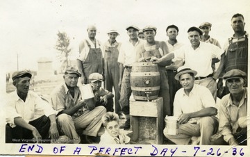 Volunteer workers at Miners Cemetery, Mt. Olive, Ill. enjoy a drink after working.