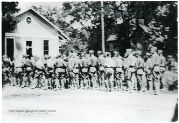 The Corps of Cadets are at rest near the C&amp;O depot on Railroad Avenue during the 4th of July parade, 1919.  'Just before the begining of Alderson, W. Va.' 