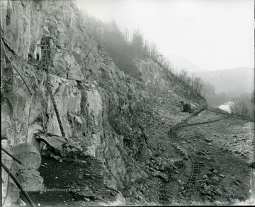 View of quarry face, showing ladders, railroad, and steam shovel, Acme Limestone Co. Ft. Spring, W.Va.