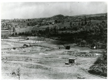 Machinery on sites of tennis court and gym foundation.