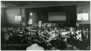 Band playing at the Army and Navy award ceremony.  Large crowd sitting in the gym.