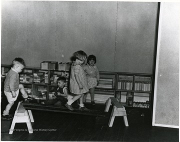 Children play with blocks and a ramp.