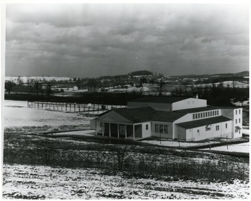 View of gymnasium and recreational center with snow on the ground.