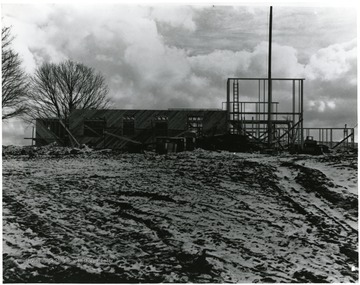 Inn being constructed while snow is on the ground.