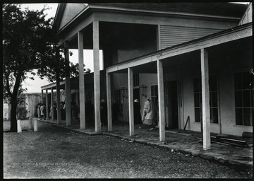 People walking on the porch of the community center.