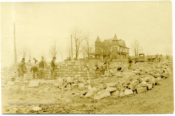 Men laying foundation for Power House.  Arthur mansion visible in the background.<br />