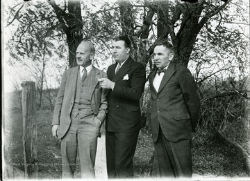 Mr. Nolan (right), Jennings Randolph (center), and Bushrod Grimes (left) speak while visiting Arthurdale in September 1933. 