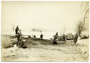 Men and machines building a road on a snowy day at Arthurdale.