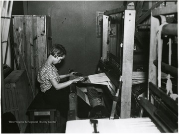 Child operates one of the cooperative looms at the Arthurdale Resettlement Project.