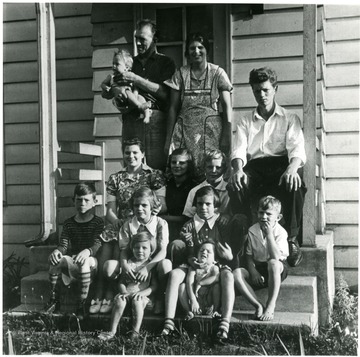 '1st row - Eleanor, Zella; 2nd row - Bert, Patty, Ann, Reta, Richard; 3rd row - Iona, Margaret, Clarence Jr.; 4th row - Mr. DeGolyier holding the baby, Mickie, Mrs. DeGolyier and Henry. A print from the Franklin D. Roosevelt Library Collection. This print is furnished for your file and must not be reproduced without the owner's permission. Owner: Womans Day Magazine. Album 359 FSA-Arthurdale, W. Va.'