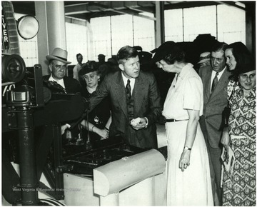 Eleanor Roosevelt tours farming equipment plant. Mrs. Henry Morgenthau (far right) 'A print from the FDR Library collection. This print is furnished for your file and must not be reproduced without the owner's permission.
