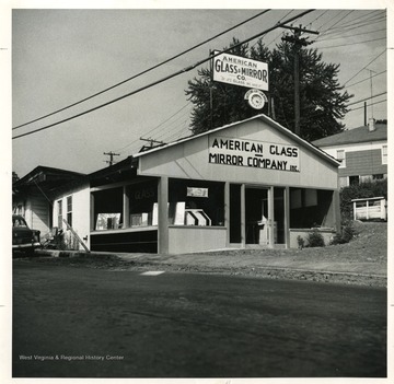 Exterior view of the American Glass and Mirror Company in Beckley, West Virginia.  'Copyrighed 1955 All rights reserved by Harlow Warren 320 North Kanawha Street Beckley, W. Va.'