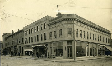 City buildings, including a Watch and Jewerly Repair shop, Pool Room, and Fruit and Confectionary on an unidentified street in Beckley, West Virginia. 