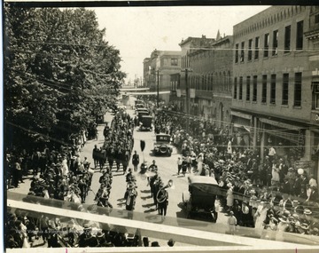 Townspeople line the street in Beckley, West Virginia to watch the marching troops.