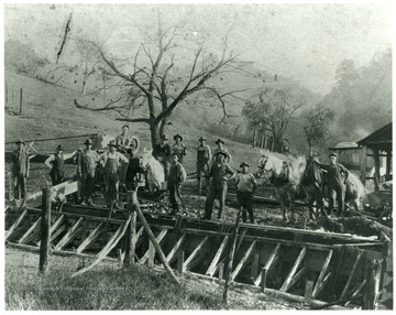 Men and horses pause form their work making a culvert.