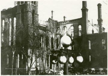 Ruins of the Capitol building after the 1921 fire.  Globe lamps visible in the foreground.