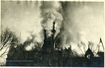 Flames and smoke come from the tower of the Capitol building.