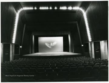 'The new West Virginia State Theater, in the Science and Cultural Center, a 500-seat facility occupying two levels, will be used for West Virginia talent--from large symphonic ensembles to small, intimate one-man performances.  The stage features a hydraulic lift which serves as apron, orchestra pit, and elevator to and from trap room.'