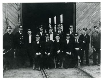 Group portrait of streetcar workers in front of a building in Clarksburg, West Virginia.