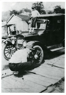 'Earl Hugh Moneypenny of Clarksburg, working on his car. Photo from 1927. Originial photo owned by a daughter, Pearl Moneypenny, of Clarksburg.'