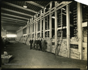 View of the interior of the Rolland Glass Plant in Clarksburg, West Virginia. 'From left to right: Albert Rolland, Charles Rolland, Ernest Rolland, Eugene Rolland, and Aristide Rolland.'
